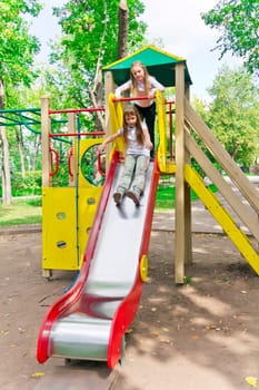 Photo of two active girls on nursery platform