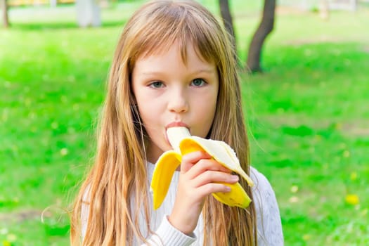Photo of girl are eating banana in summer