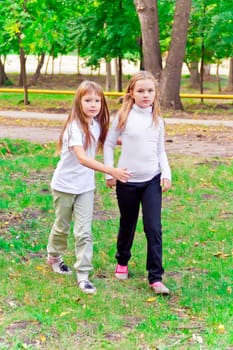 Photo of two walking girls in summer