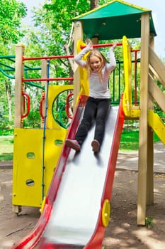Photo of active girl on nursery platform in summer