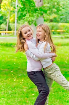 Photo of two playing girls in summer