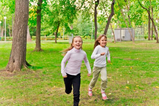 Photo of two running girls in summer