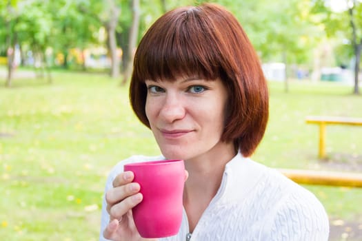 Photo of woman with brown hair drinking tea