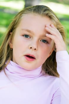 Cute girl with blond long hair and blue eyes