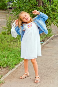 Cute girl playing with white bag in summer