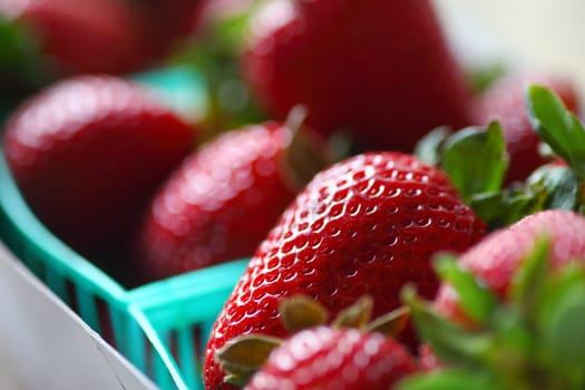 Closeup of ripe berries in plastic market baskets