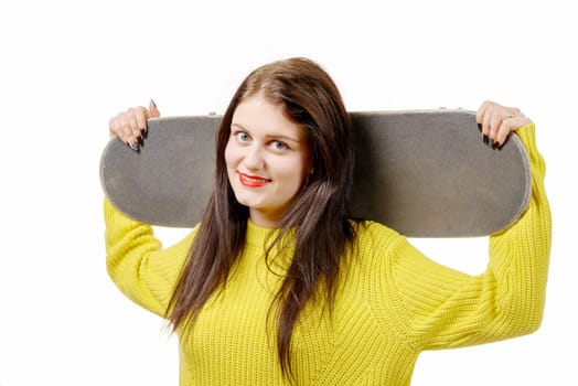 a smiling skater girl holding skateboard on white