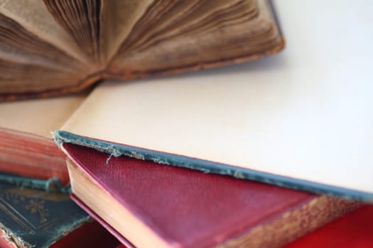 Old books stacked, two open with room for text