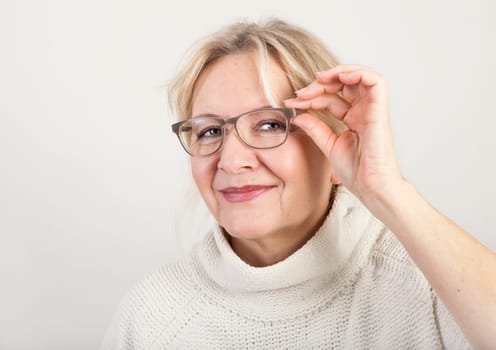 an older blonde woman with glasses portrait
