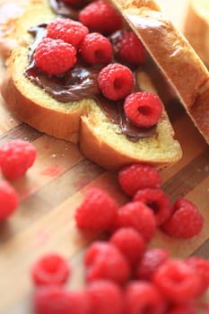 Brioche slices with chocolate spread and fresh raspberries