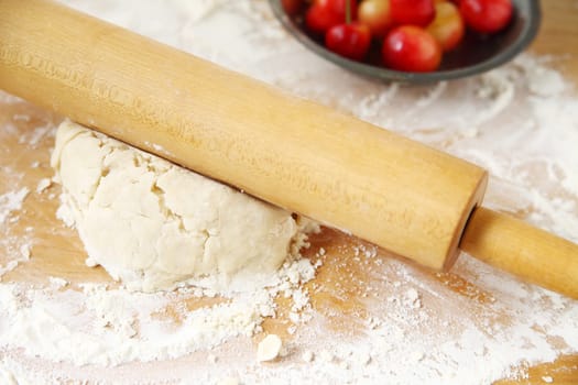 Rolling out dough  on floured surface for a cherry pie