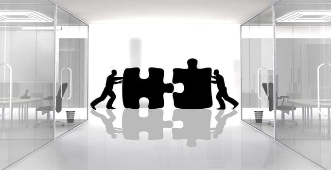Concept of two workers assembling jigsaw pieces. Two team members are working together in order to achieve the same goal.