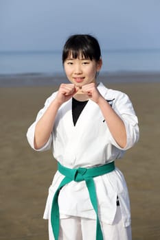 KAGAWA, JAPAN - Jan 3: Japanese karate girl of fighting-pose in midwinter at Ichinomiya Beach, January 3, 2016, Kagawa, Japan
