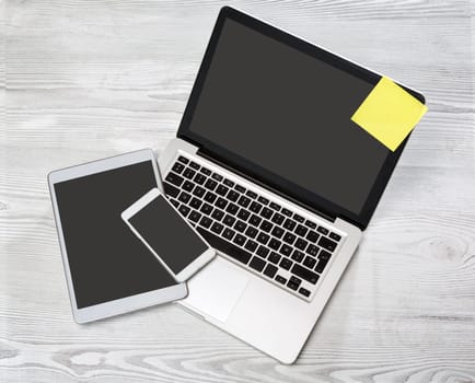 View of a Laptop in high definition with tablet and mobile on a wood background