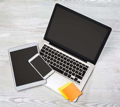 View of a Laptop in high definition with tablet and mobile on a wood background