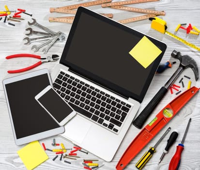 View of a Wood handyman's desk in high definition with laptop, tablet and mobile