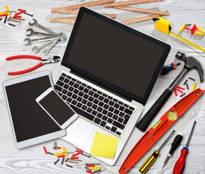 View of a Wood handyman's desk in high definition with laptop, tablet and mobile