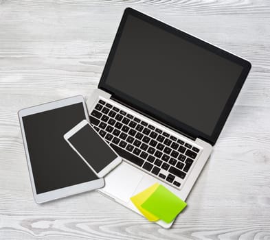 View of a Laptop in high definition with tablet and mobile on a wood background