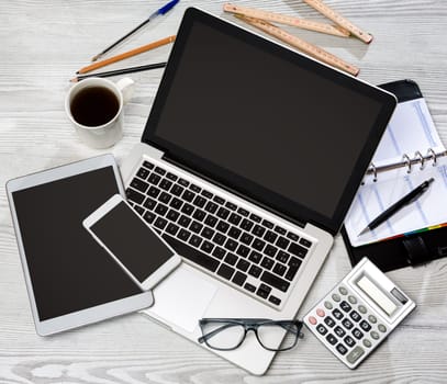 View of a Wood businessman's desk in high definition with laptop, tablet and mobile