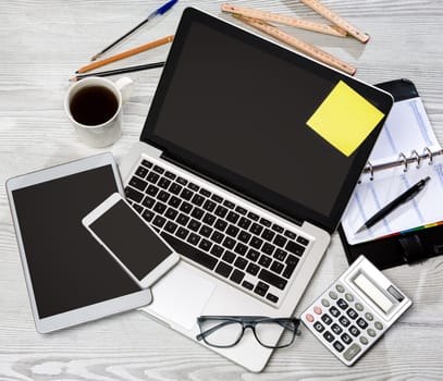 View of a Wood businessman's desk in high definition with laptop, tablet and mobile