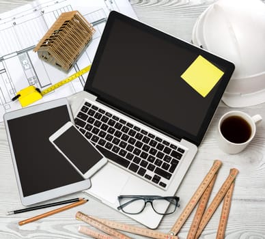 View of a Wood architect's desk in high definition with laptop, tablet and mobile