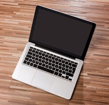 View of a Laptop in high definition on a wood background