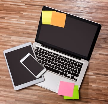 View of a Laptop in high definition with tablet and mobile phone on a wood background