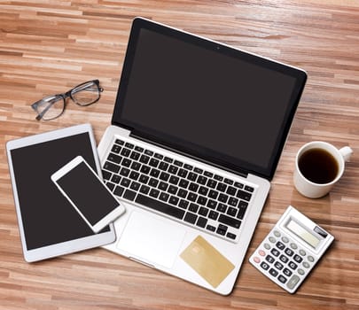VIew of a Wood businessman's desk in high definition with laptop, tablet and mobile