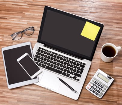 View of a Wood businessman's desk in high definition with laptop, tablet and mobile