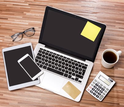 VIew of a Wood businessman's desk in high definition with laptop, tablet and mobile