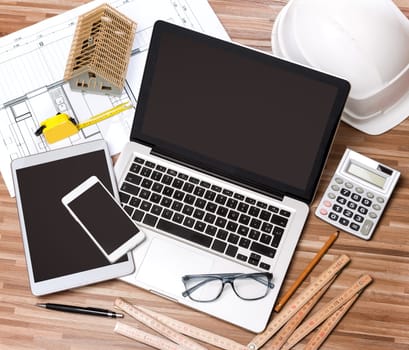 View of a Wood architect's desk in high definition with laptop, tablet and mobile