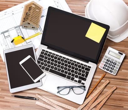 View of a Wood architect's desk in high definition with laptop, tablet and mobile