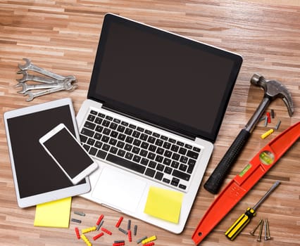 View of a Wood handyman's desk in high definition with laptop, tablet and mobile