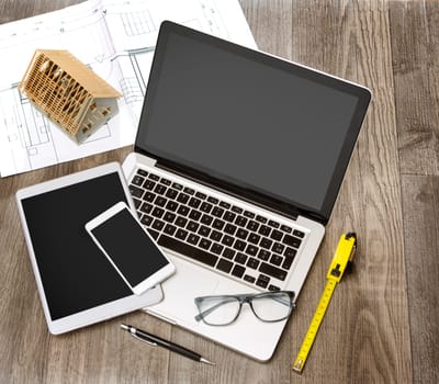 View of a Wood architect's desk in high definition with laptop, tablet and mobile