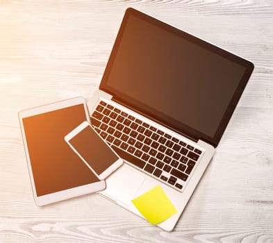 View of a Laptop in high definition with tablet and mobile on a wood background