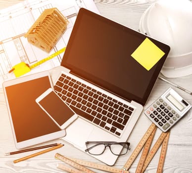 View of a Wood architect's desk in high definition with laptop, tablet and mobile