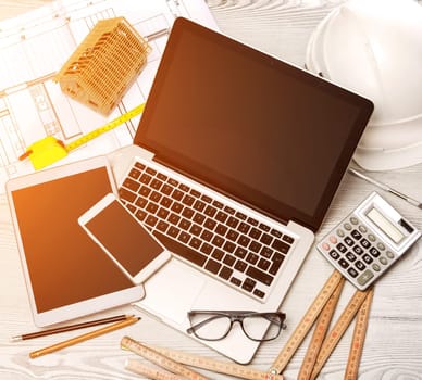View of a Wood architect's desk in high definition with laptop, tablet and mobile