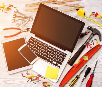 View of a Wood handyman's desk in high definition with laptop, tablet and mobile