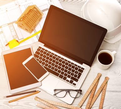 View of a Wood architect's desk in high definition with laptop, tablet and mobile