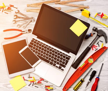 View of a Wood handyman's desk in high definition with laptop, tablet and mobile