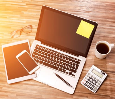 View of a Wood businessman's desk in high definition with laptop, tablet and mobile