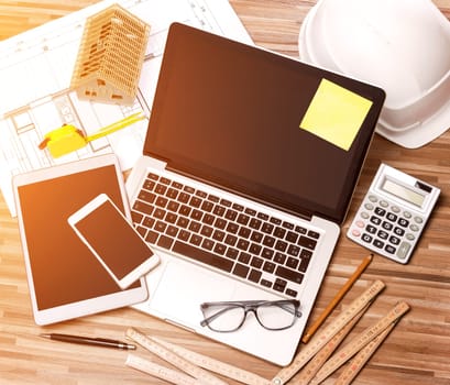 View of a Wood architect's desk in high definition with laptop, tablet and mobile