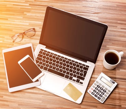 VIew of a Wood businessman's desk in high definition with laptop, tablet and mobile