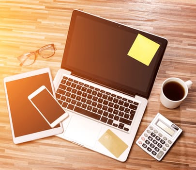 VIew of a Wood businessman's desk in high definition with laptop, tablet and mobile