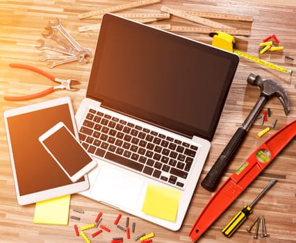 View of a Wood handyman's desk in high definition with laptop, tablet and mobile