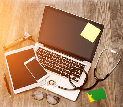 View of a Wood doctor's desk in high definition with laptop, tablet and mobile phone