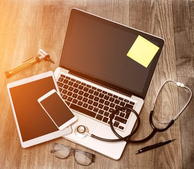 View of a Wood doctor's desk in high definition with laptop, tablet and mobile phone