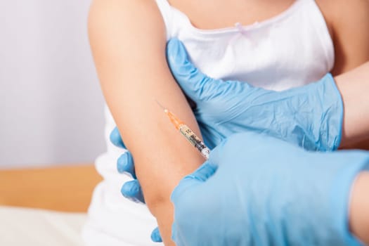 Doctor vaccinating a little girl. Isolated over white background