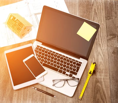 View of a Wood architect's desk in high definition with laptop, tablet and mobile