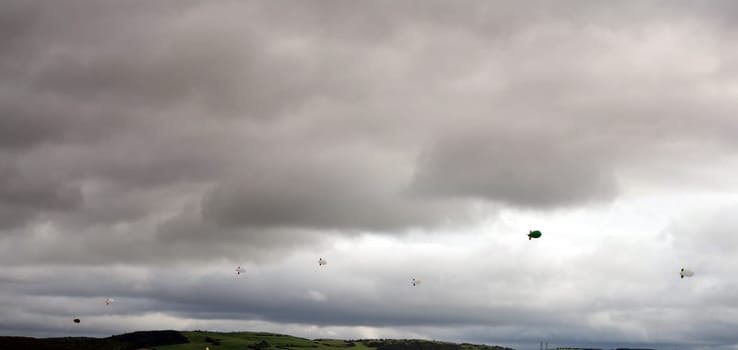 clouds full of air blimps high in the grey sky